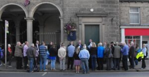 Crowd at unveiling of blue plaque