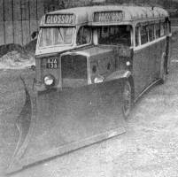 Photograph of a bus with a snow plough