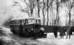 Photograph of bus with a snow plough