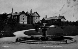 Photograph showing Wood's Hospital and the fountain in Howard Park, Glossop 1944