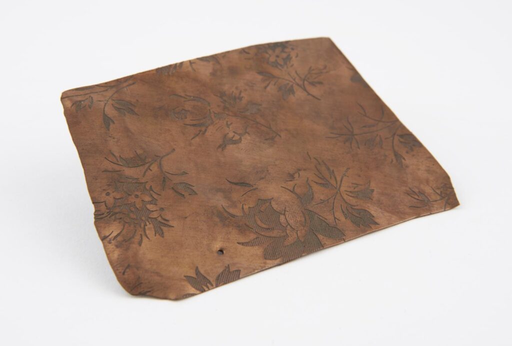 A piece from a copper roller used in calico printing