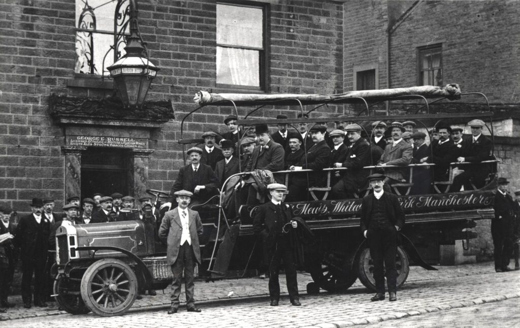 A black and white photograph of a charabanc outside the Albion Hotel, Victoria Street, Glossop